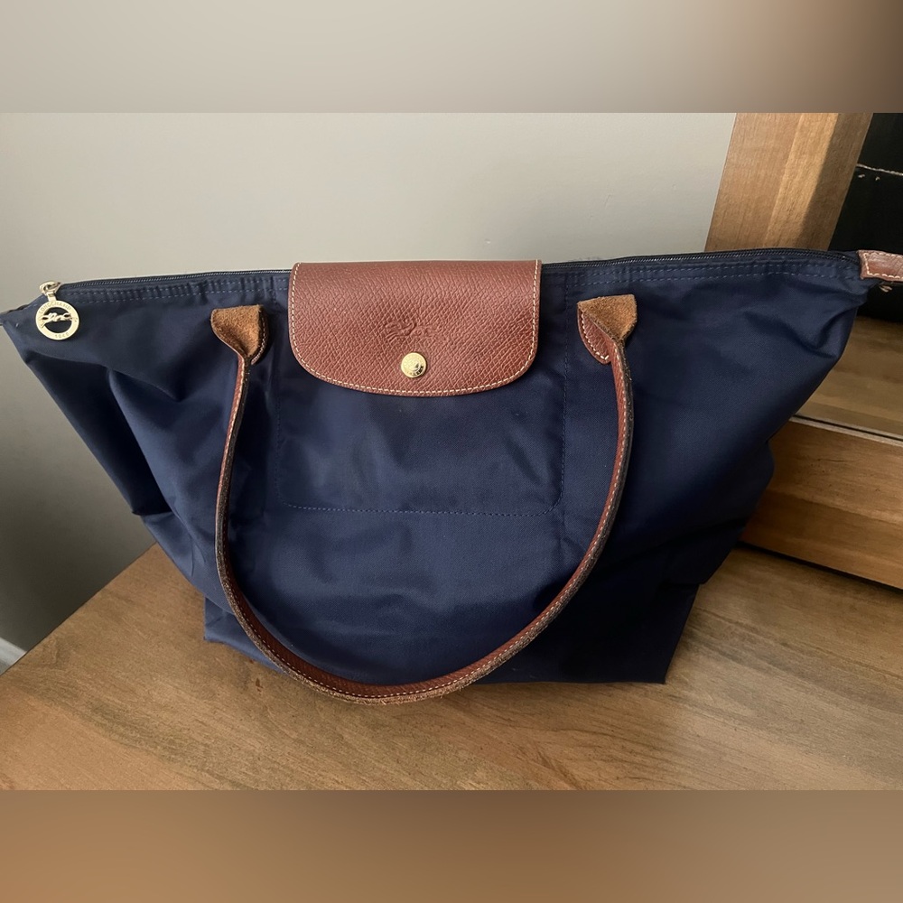 Large navy blue Long Champ tote with brown leather shoulder carry handles
